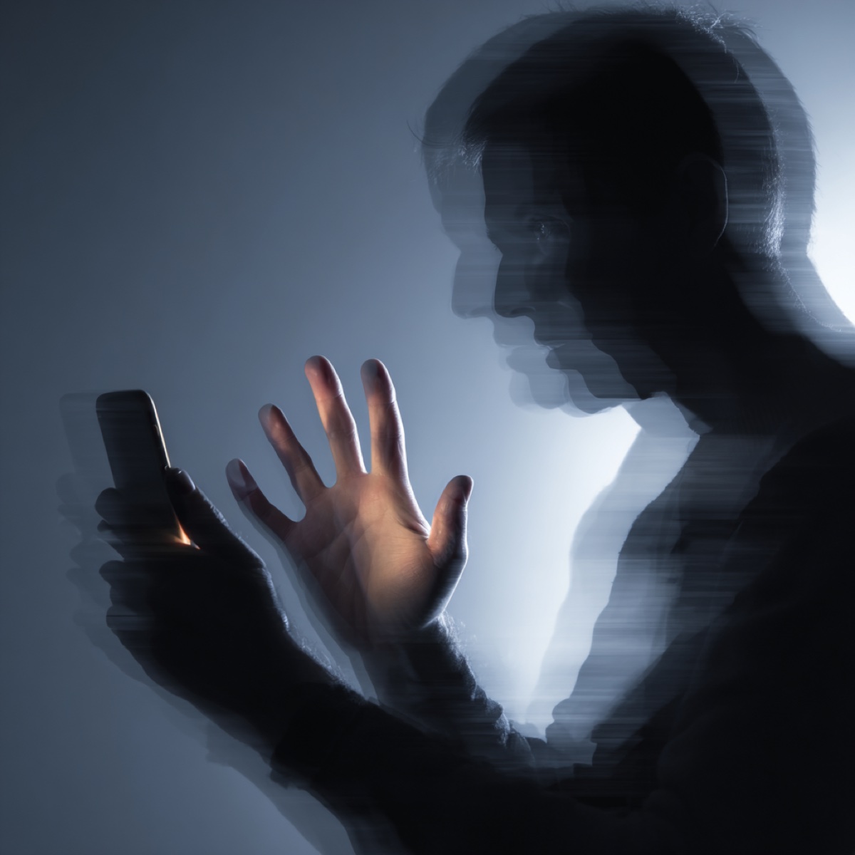 Help victim extortion growing digital threat - silhouetted figure representing cybercriminal threatening vulnerable victim through digital intimidation