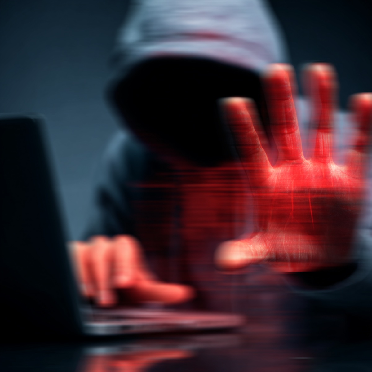 Matchup blackmail so devastating - hooded cybercriminal with threatening red glowing hand representing immediate demands blackmailers typically give victims only hours to comply with financial extortion threats