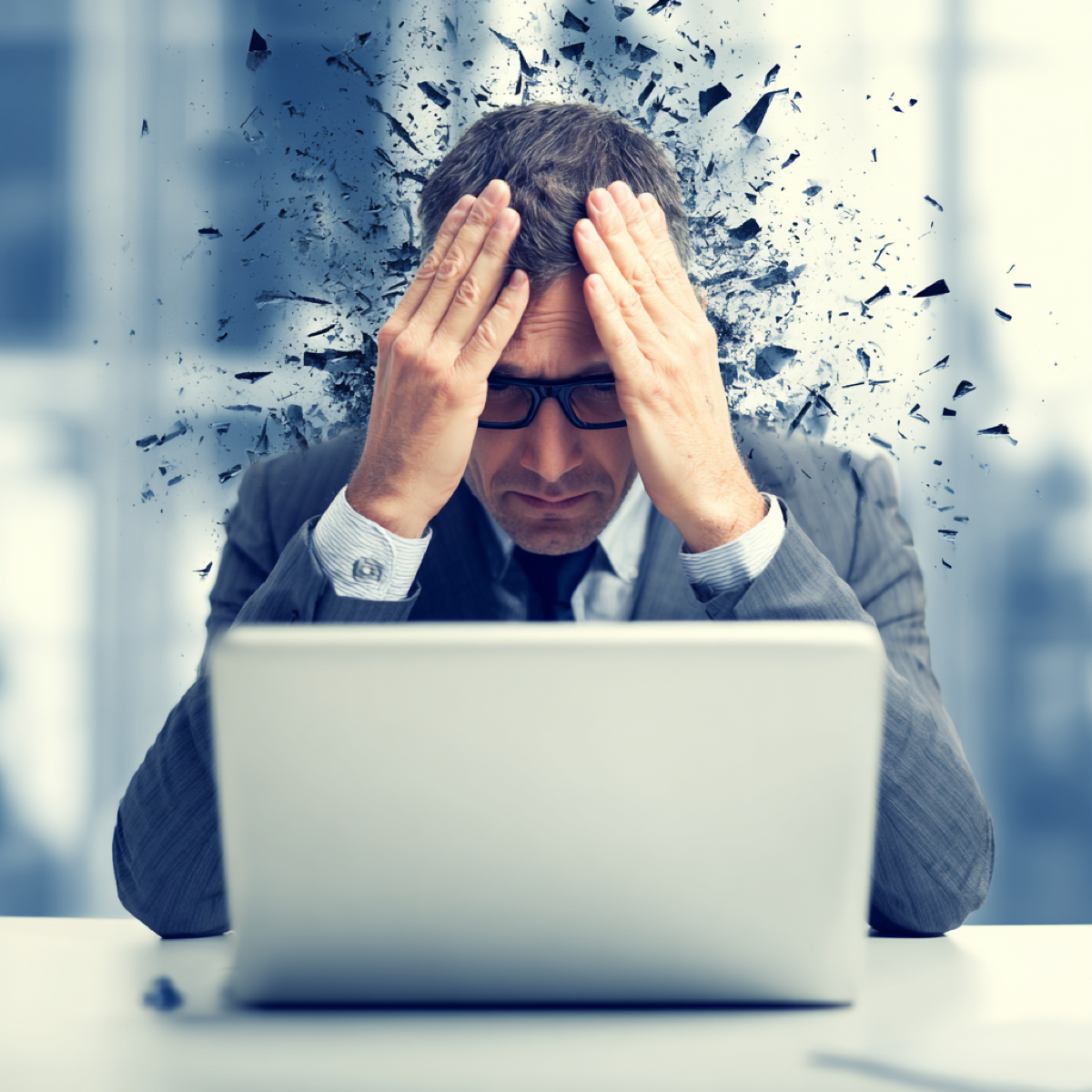Remove online defamation destroying reputation - businessman overwhelmed by mental fragmentation and stress from laptop representing devastating impact of defamatory online content