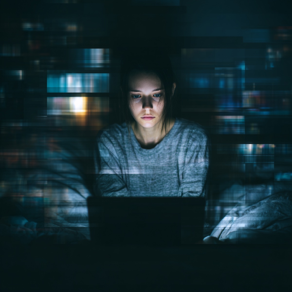 Sextortion reporting support process - woman victim receiving professional cybersecurity assistance while working on laptop