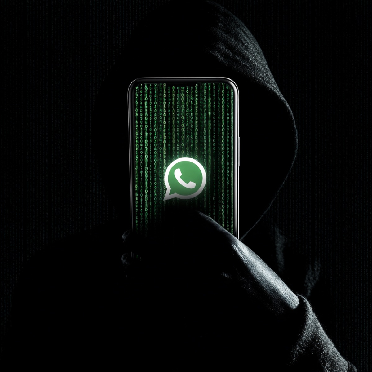 WhatsApp blackmail alarming rate - hooded cybercriminal with phone displaying matrix code showing encryption vulnerability exploitation